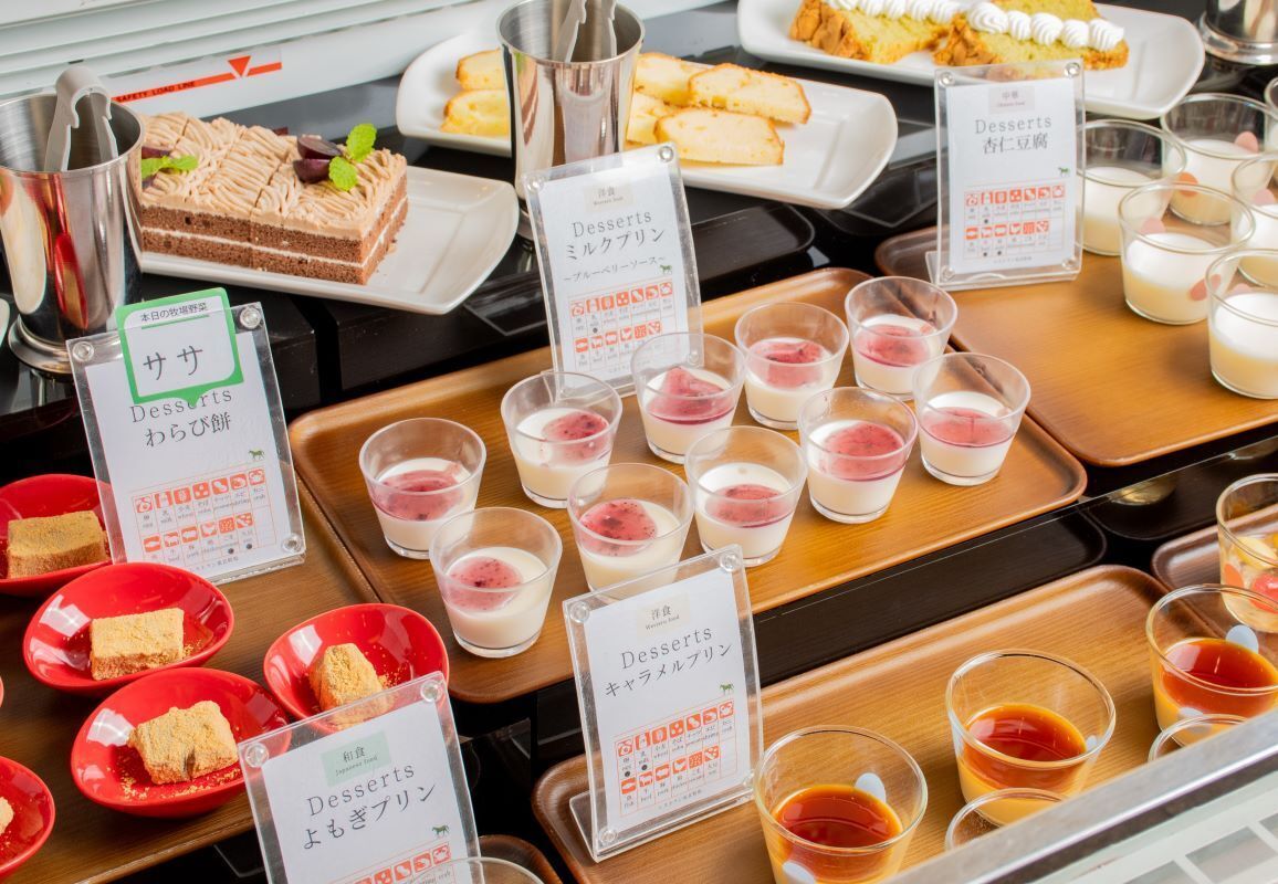 A dessert display with various sweets and beverages.