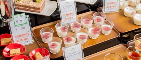 A dessert display with various sweets and beverages.