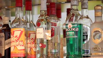 A variety of alcohol bottles on a shelf.