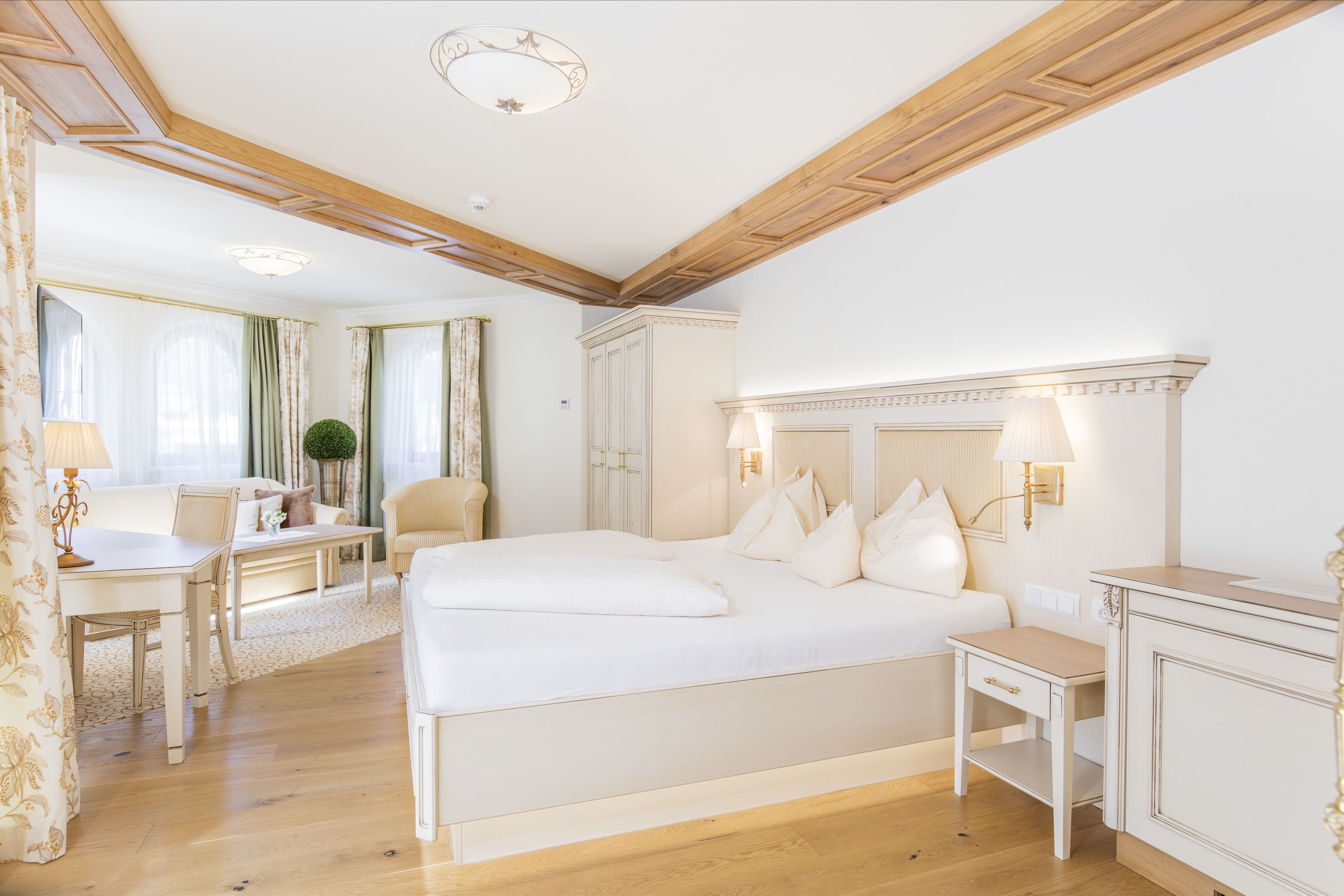 Ein geräumiges Schlafzimmer mit einem großen Bett, einem Schreibtisch und einem Sessel.