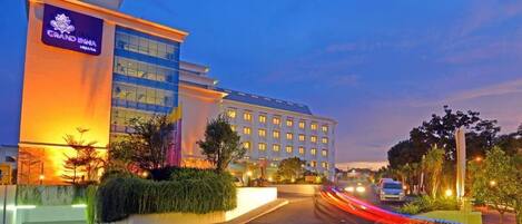 A hotel with a modern facade, large windows, and a well-lit entrance.