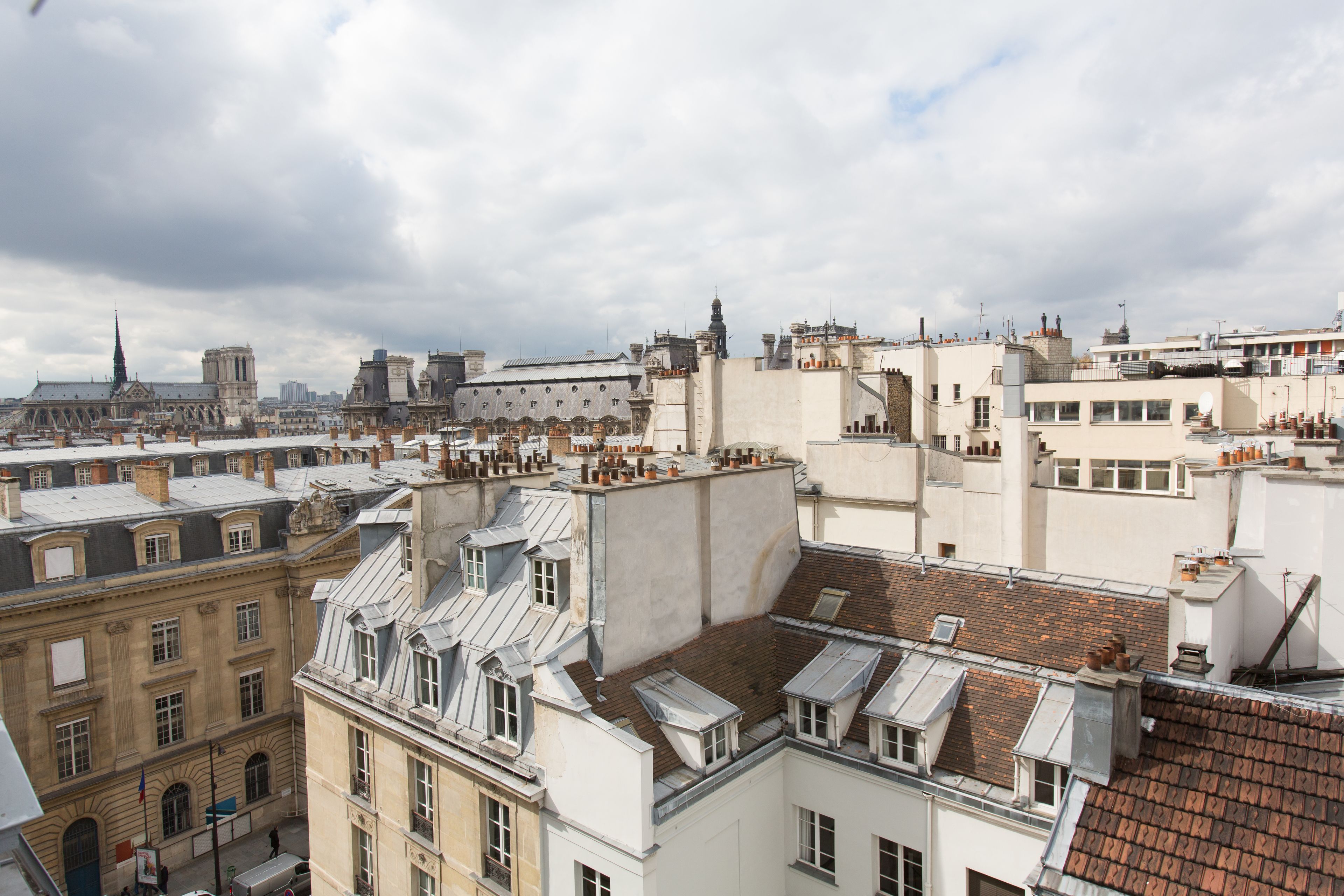 A high-rise building with multiple balconies, large windows, and a mix of architectural styles.