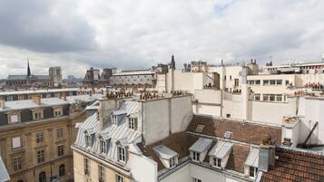 Un edificio alto con varios balcones, ventanas grandes y una mezcla de estilos arquitectónicos.