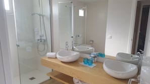 A modern bathroom with two large white sinks, a glass shower enclosure, and a wooden vanity. - R2 Buganvilla Hotel & SPA (Pajara)