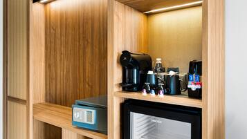 A compact kitchenette with a coffee maker, a mini-fridge, and a microwave.