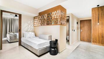 A modern bedroom with a bed, a wooden partition, and a wardrobe.