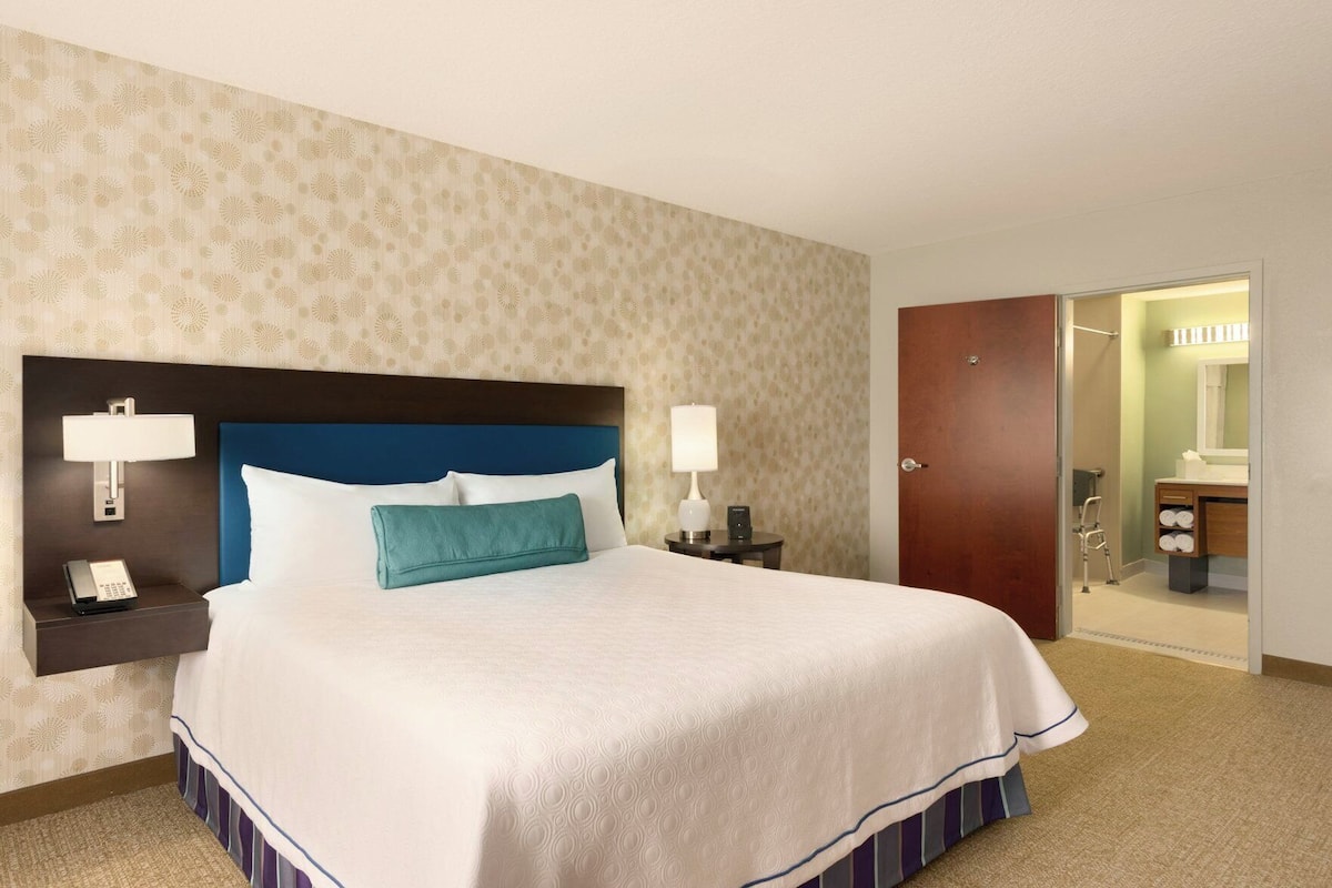 Premium bedding, desk, laptop workspace, blackout curtains