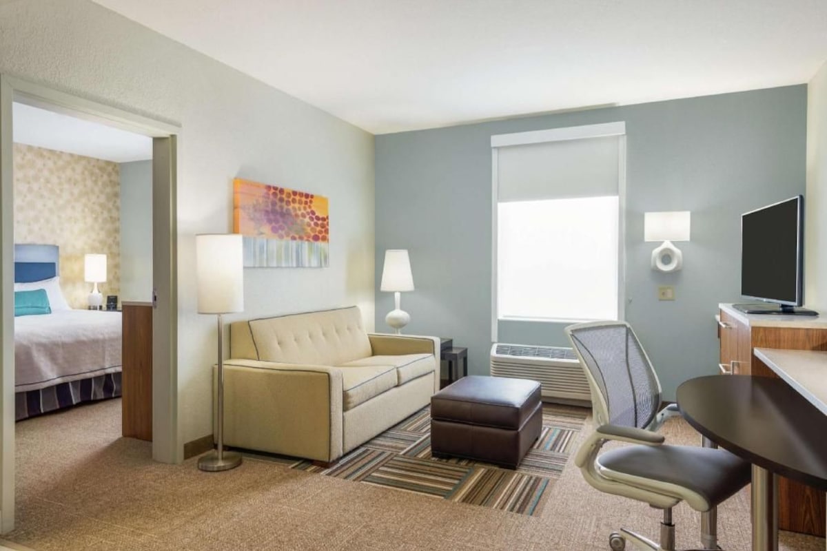 Premium bedding, desk, laptop workspace, blackout drapes
