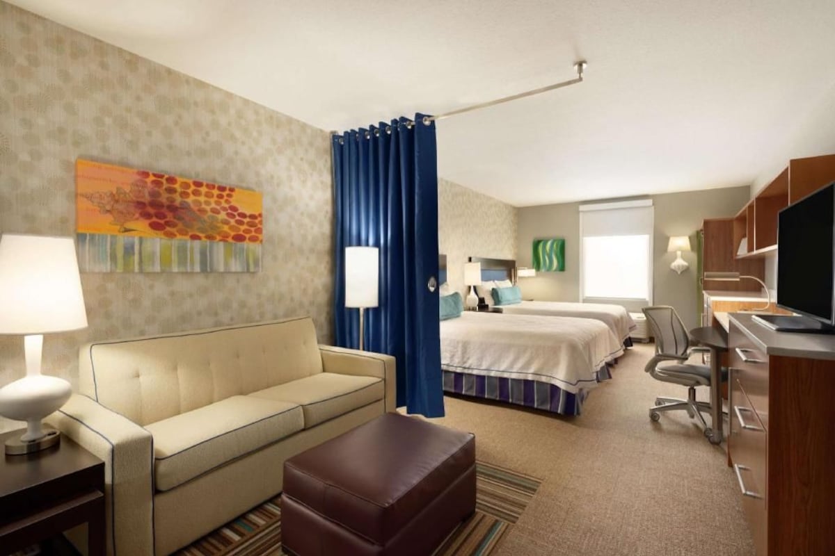 Premium bedding, desk, laptop workspace, blackout drapes