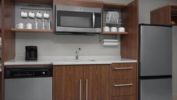 Fridge, microwave, coffee/tea maker, cookware/dishes/utensils