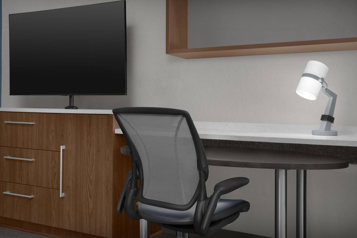 Premium bedding, desk, laptop workspace, blackout curtains