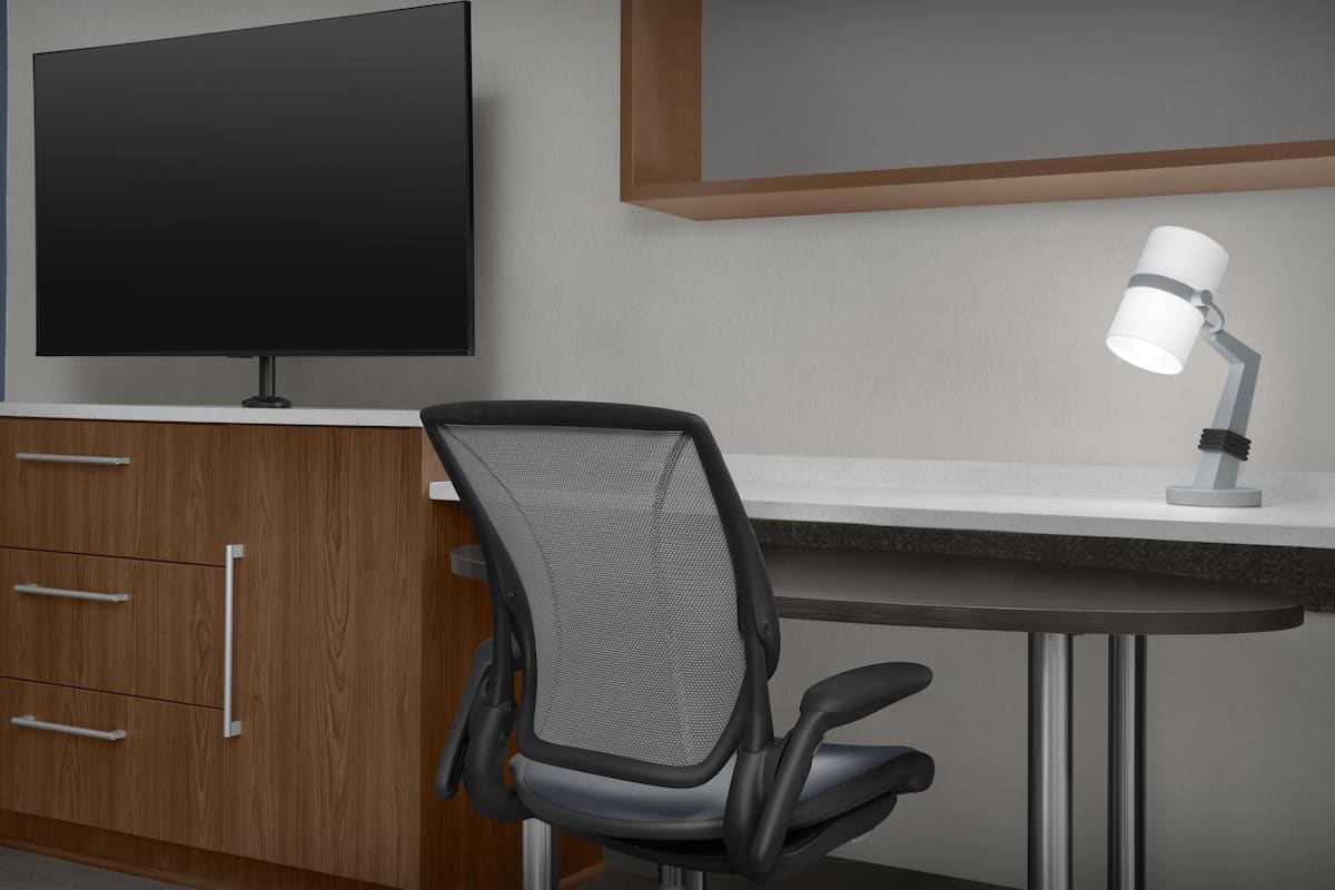 Premium bedding, desk, laptop workspace, blackout drapes
