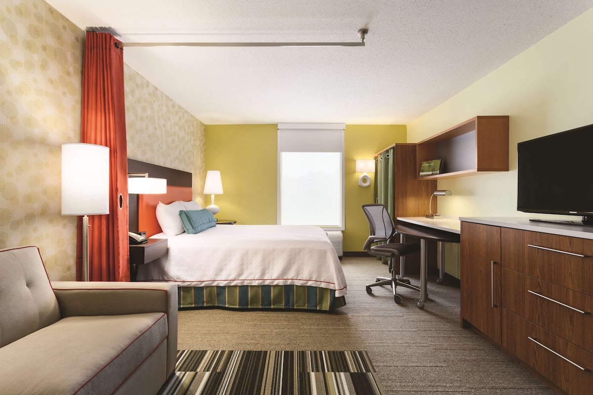 Premium bedding, desk, laptop workspace, blackout curtains