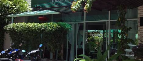 A building with a sign reading "The Hacienu (Touch Village)".
