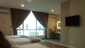 A hotel room with two beds, a desk, a chair, a television, and a window with curtains. - Midcity Hotel Melaka (Malacca City)