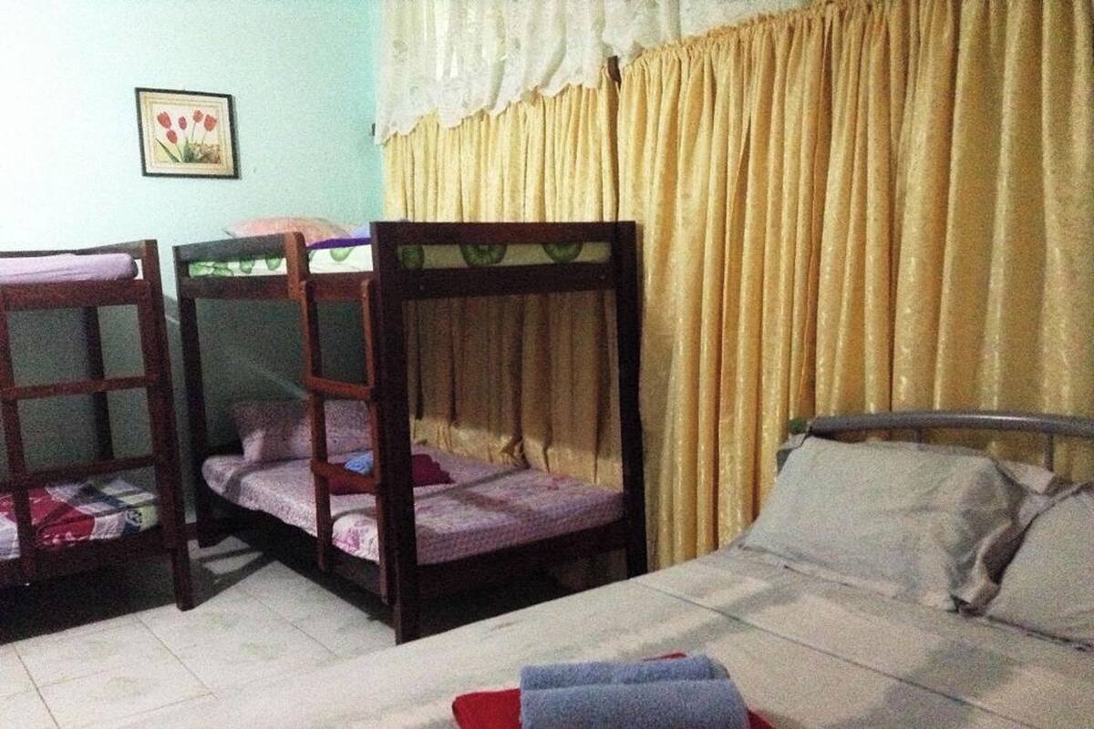 A room with bunk beds and a single bed.