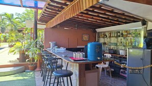 A bar area with stools, a blue cooler, and a refrigerator with an off limits sign. - Citadel Bed and Breakfast (Puerto Princesa)