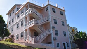 A multi-story building with balconies and a staircase. - Aanola Villas (Castries)