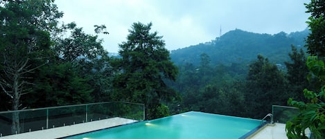 Outdoor pool, open 8:00 AM to 6:00 PM, pool umbrellas