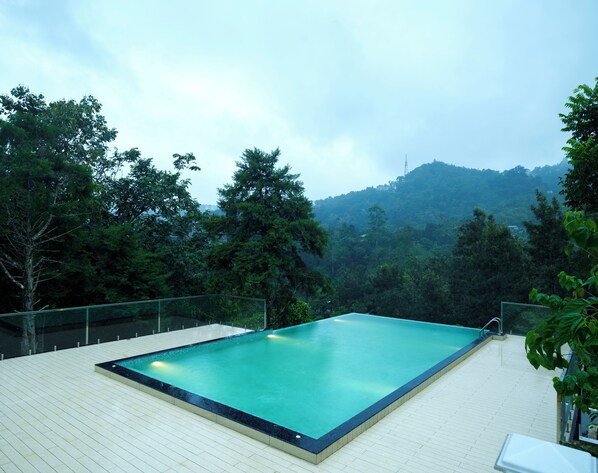 Outdoor pool, open 8:00 AM to 6:00 PM, pool umbrellas