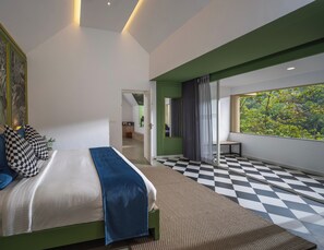 A modern bedroom with a bed, checkered floor, a large window with a view, and a green accent wall.