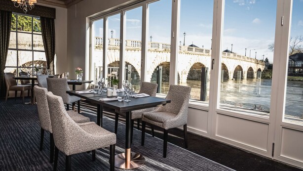 A dining area with a view of a stone bridge over water. - Thames Riviera Hotel, Sure Hotel Collection by Best Western (Maidenhead)