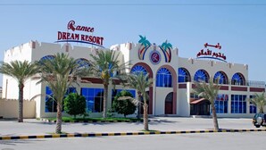 A Dream Resort building with palm trees in front. - Ramee Dream Resort (Seeb)