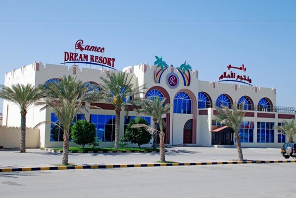 A Dream Resort building with palm trees in front.