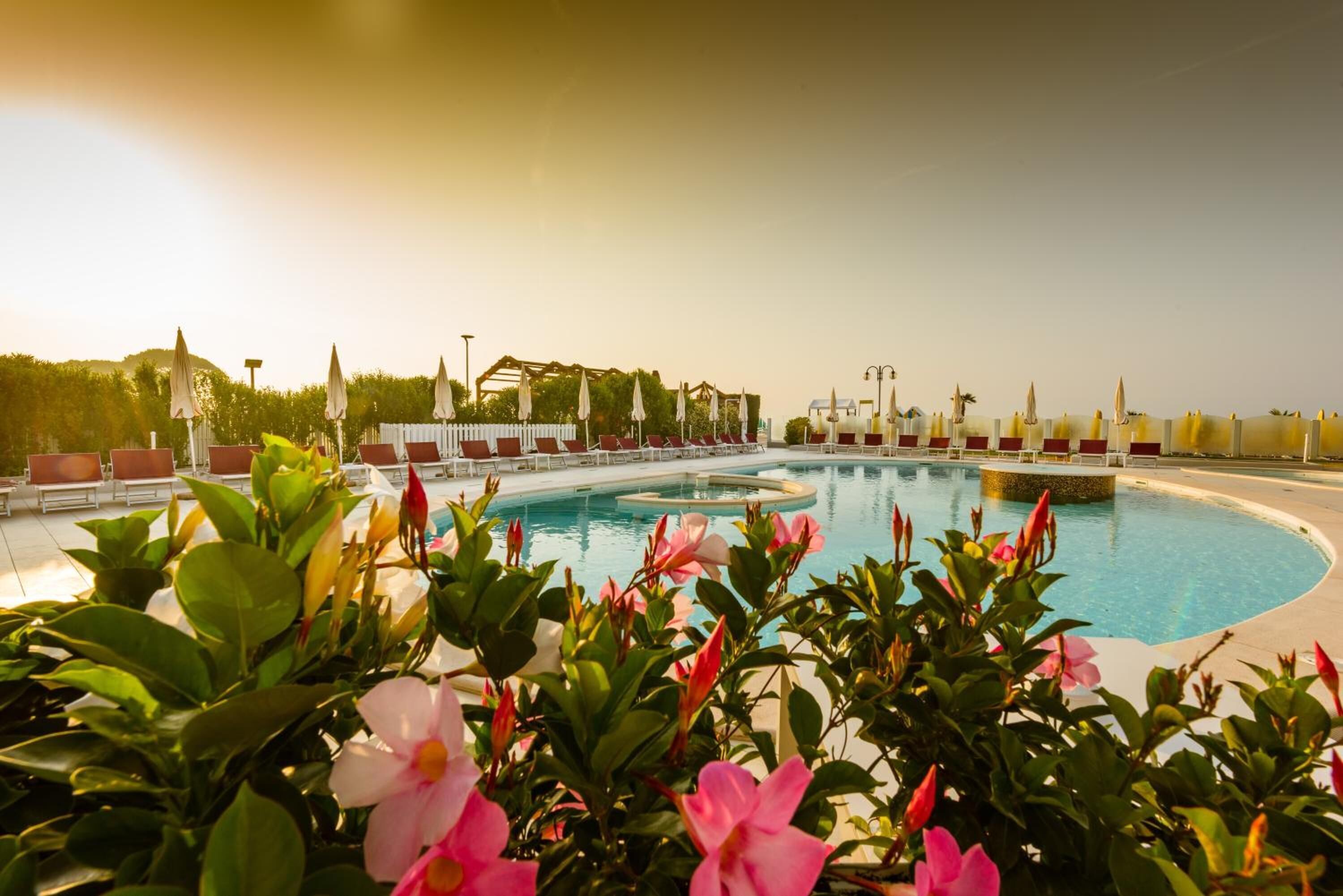 seasonal outdoor pool, a rooftop pool, pool umbrellas, pool loungers