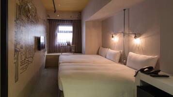 A hotel room with two beds, a desk with a telephone, and a wall-mounted TV.