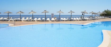 Piscine extérieure, parasols de plage, chaises longues