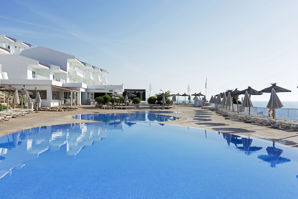 Outdoor pool, open 10:00 AM to 6:00 PM, pool umbrellas, pool loungers