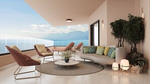 A modern living room with a sofa, chairs, a coffee table, and a view of the sea.