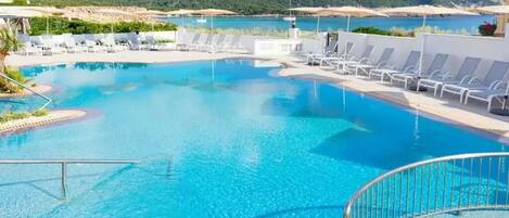 Outdoor pool, open 9:00 AM to 8:00 PM, pool umbrellas, pool loungers