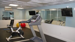 A gym with a treadmill, exercise balls, and weights. - Bar Harbor Grand Hotel (Bar Harbor)