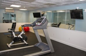 A gym with a treadmill, exercise balls, and weights. - Bar Harbor Grand Hotel (Bar Harbor)