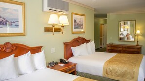 A hotel room with two beds, a wooden headboard, a bedside table with a lamp, a telephone, and a wall-mounted air conditioner. - Bar Harbor Grand Hotel (Bar Harbor)