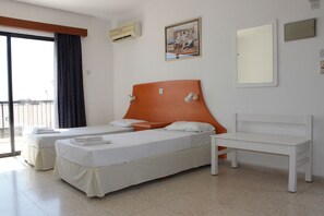 A hotel room with two beds, a bench, a painting, and a window with curtains. - Florea Hotel Apartments (Ayia Napa)