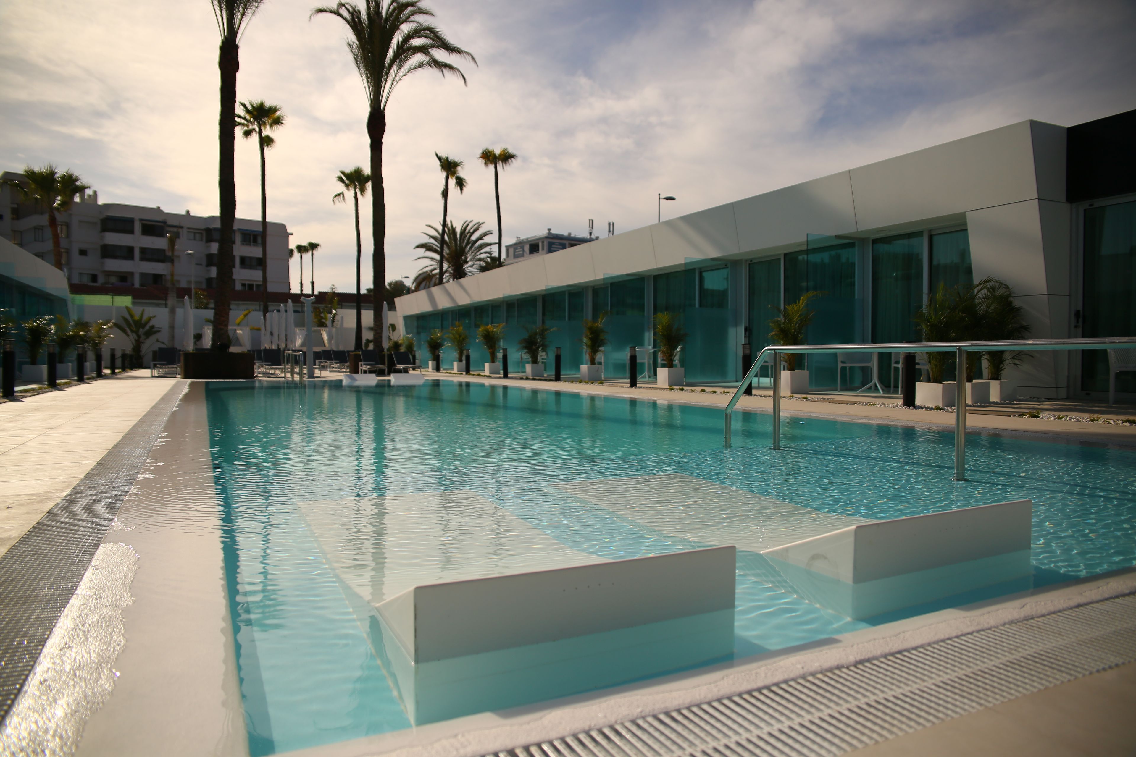 A swimming pool with a modern building in the background.
