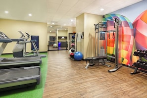 A gym with treadmills, a bench, a squat rack, and colorful exercise balls. - Hotel Indigo Cleveland-Beachwood by IHG (Beachwood)