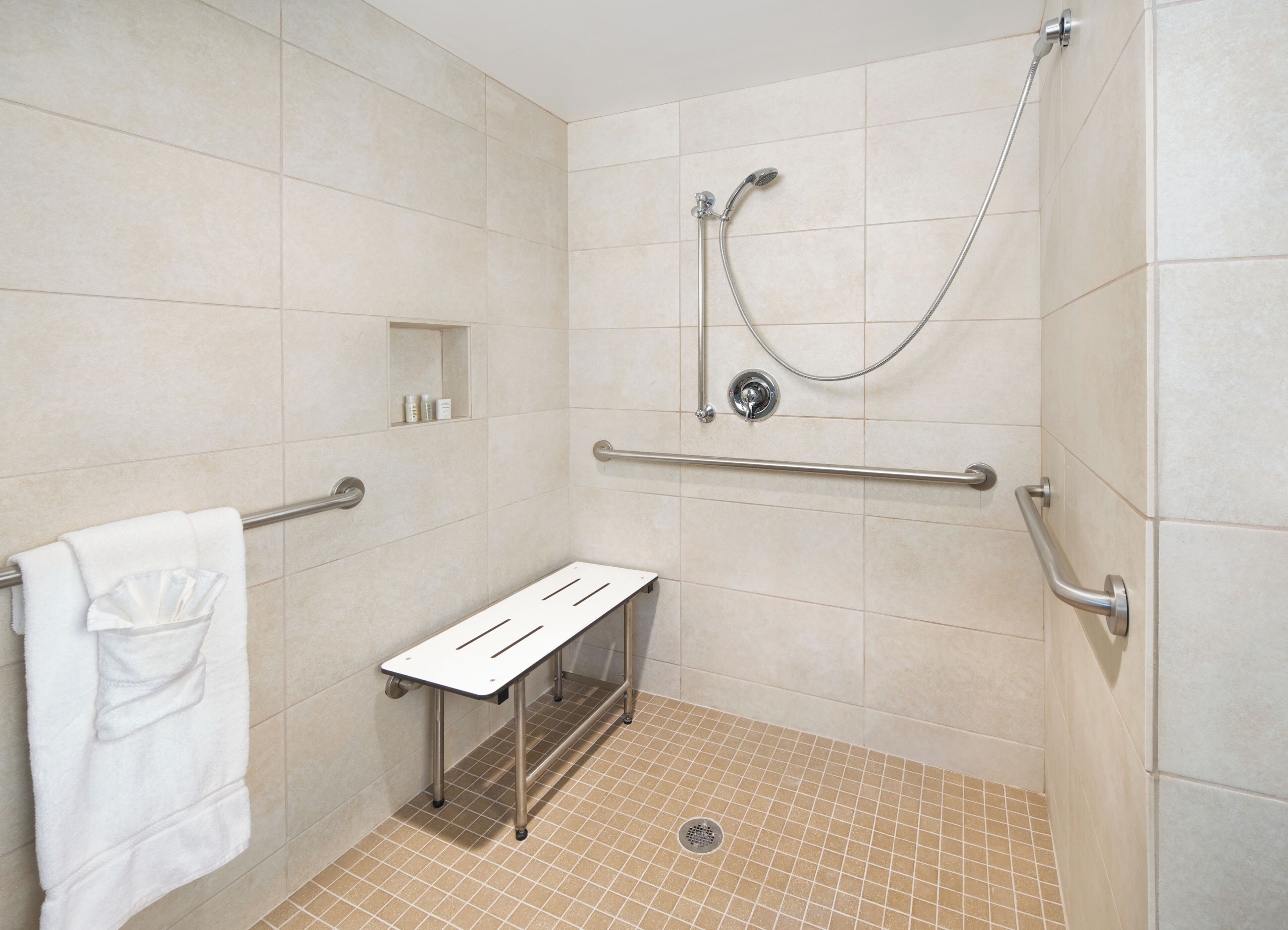 suite, 1 king bed, mobility accessible (transfer shower) | bathroom | shower, hydromassage showerhead, free toiletries, hair dryer