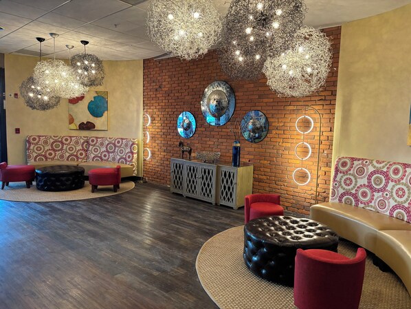 Un espace de détente moderne avec un mur en briques, des sièges disposés en cercle et un éclairage décoratif.
