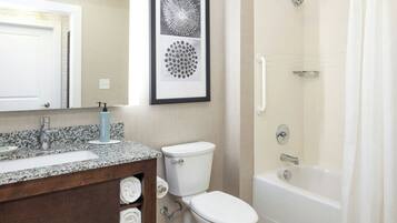 A bathroom with a sink, toilet, and bathtub.