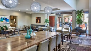 A spacious dining area with a long wooden table, multiple chairs, and decorative spherical light fixtures. - Residence Inn Nashville SE/Murfreesboro (Murfreesboro)