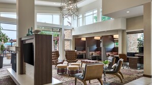 A spacious lobby with a large seating area, a flat-screen TV, and a dining setup. - Residence Inn Nashville SE/Murfreesboro (Murfreesboro)