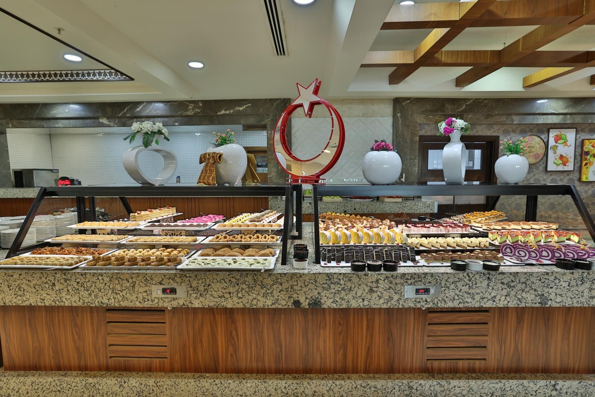 A buffet with various desserts and pastries.