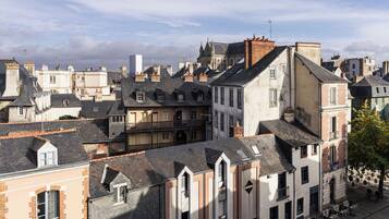 A historic European town with varied architecture, including buildings with steep roofs and a prominent church.
