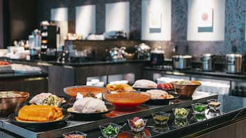 A buffet with various dishes and condiments.