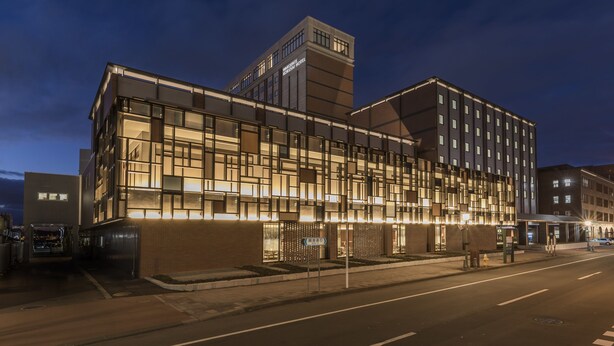 A modern hotel with a glass facade, a brick base, and a prominent tower. - Hakodate Kokusai Hotel (Hakodate)