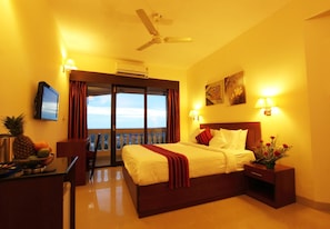 Relax in comfort with a large bed, flat-screen TV, and ceiling fan.